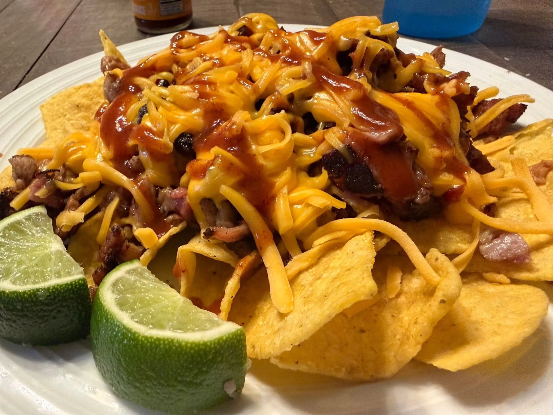 Loaded BBQ brisket nachos with cheddar and house sauce