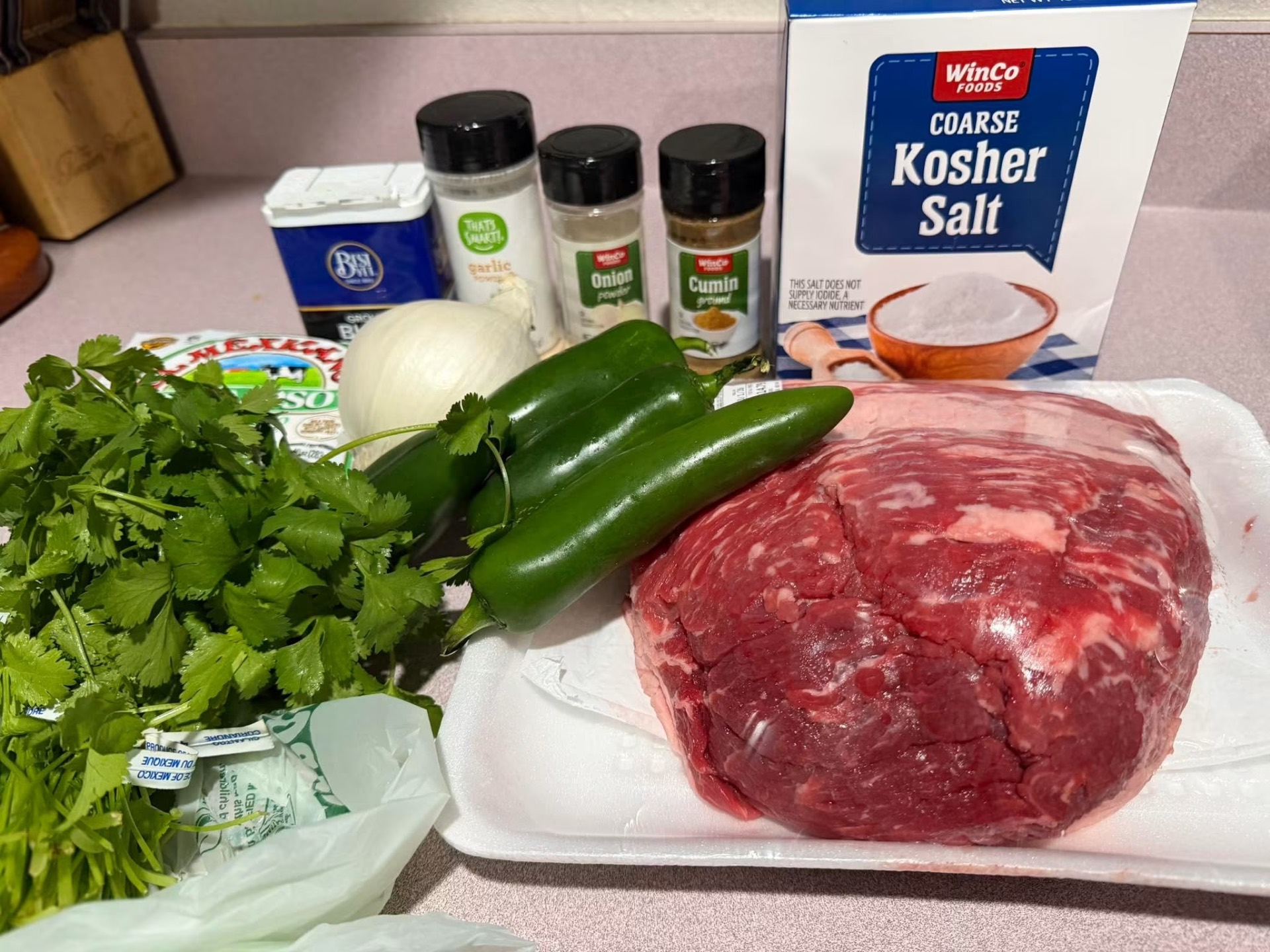 Prime brisket and fresh ingredients prepped for the smoker